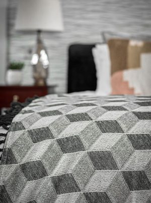 close up of throw on bed